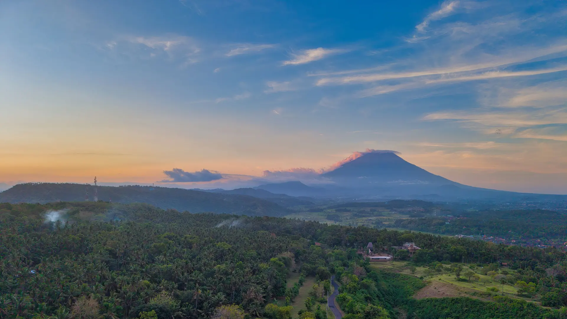 Mount Agung at sunrise above the forest