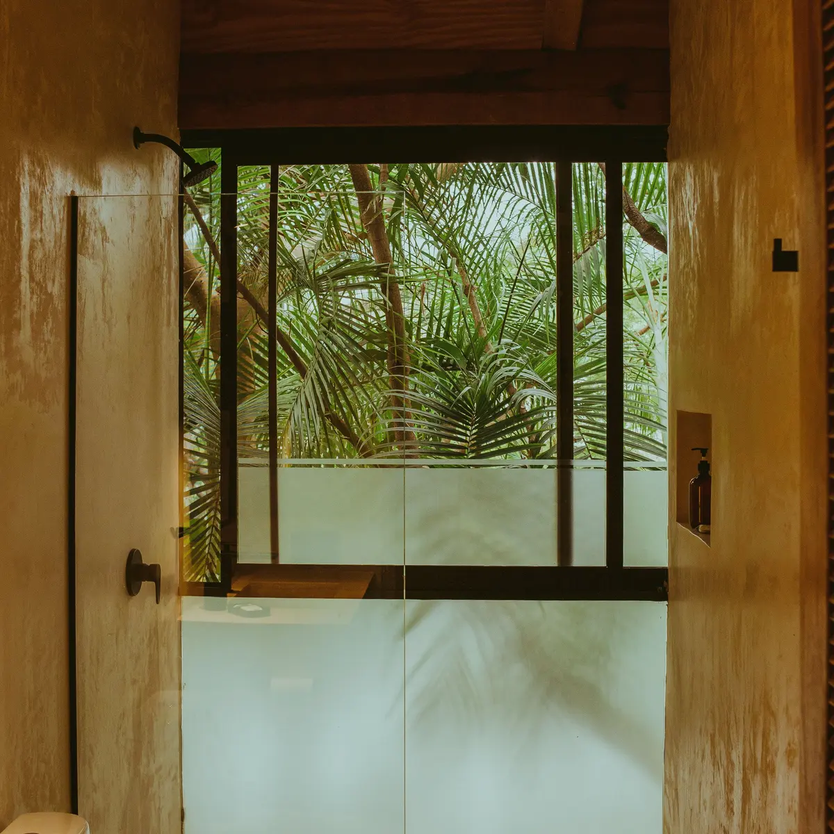 Bathroom with a window onto tropical plants
