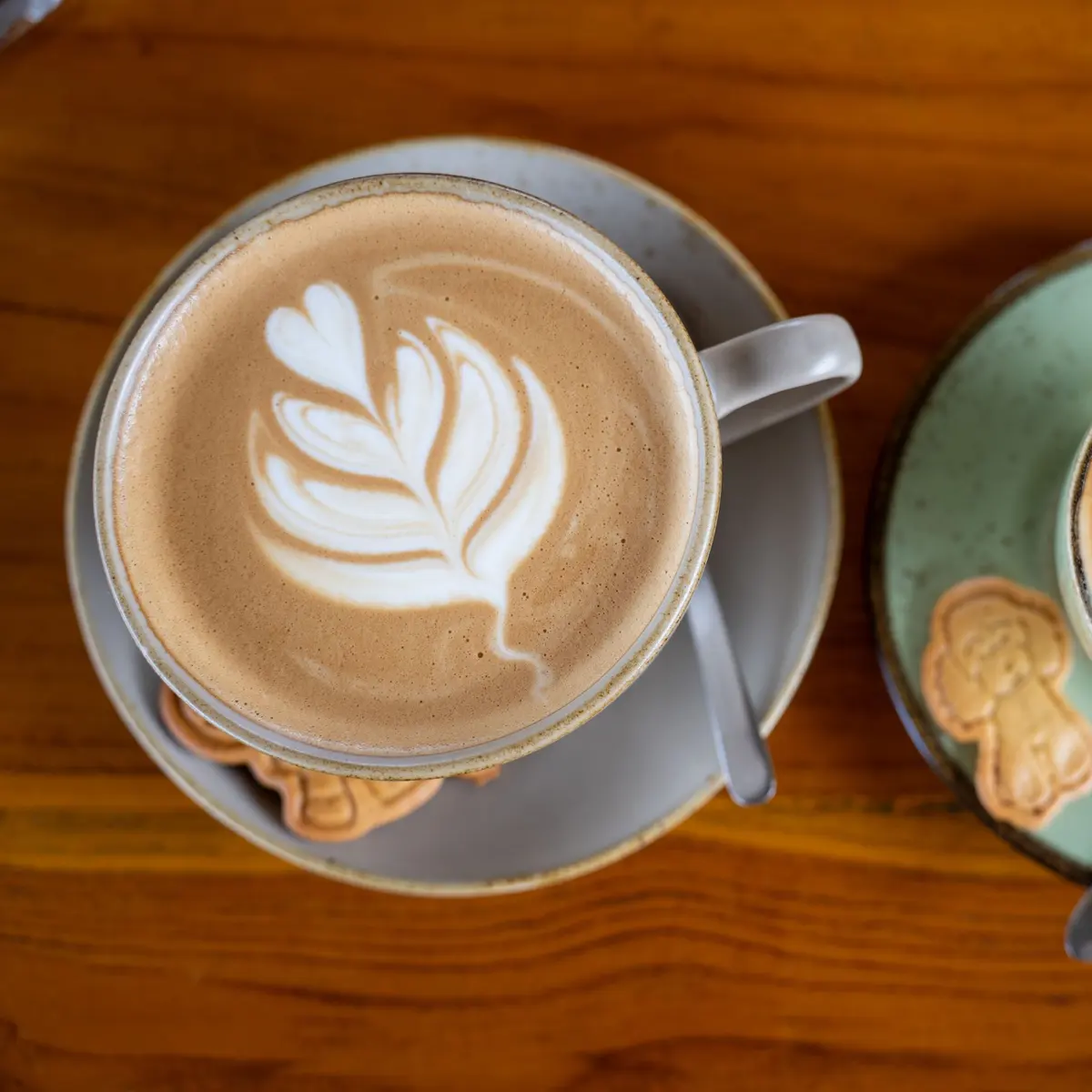 Two cups of coffee on a wooden table