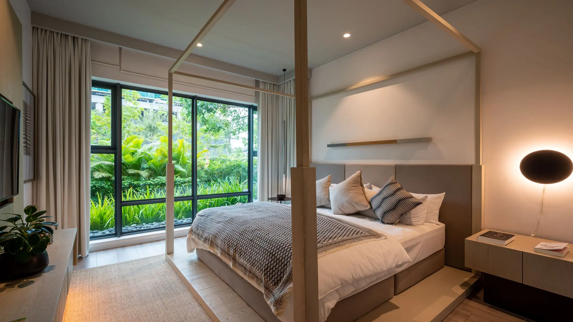 Bedroom with a window onto green plants